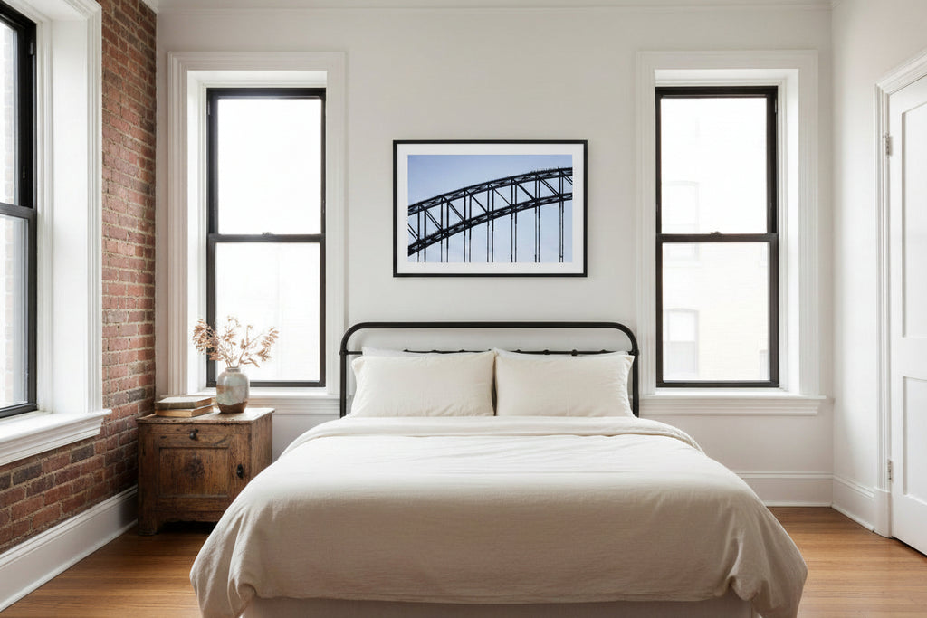 Sydney Harbour Bridge and BridgeClimb climbers as silhouettes against blue sky.
