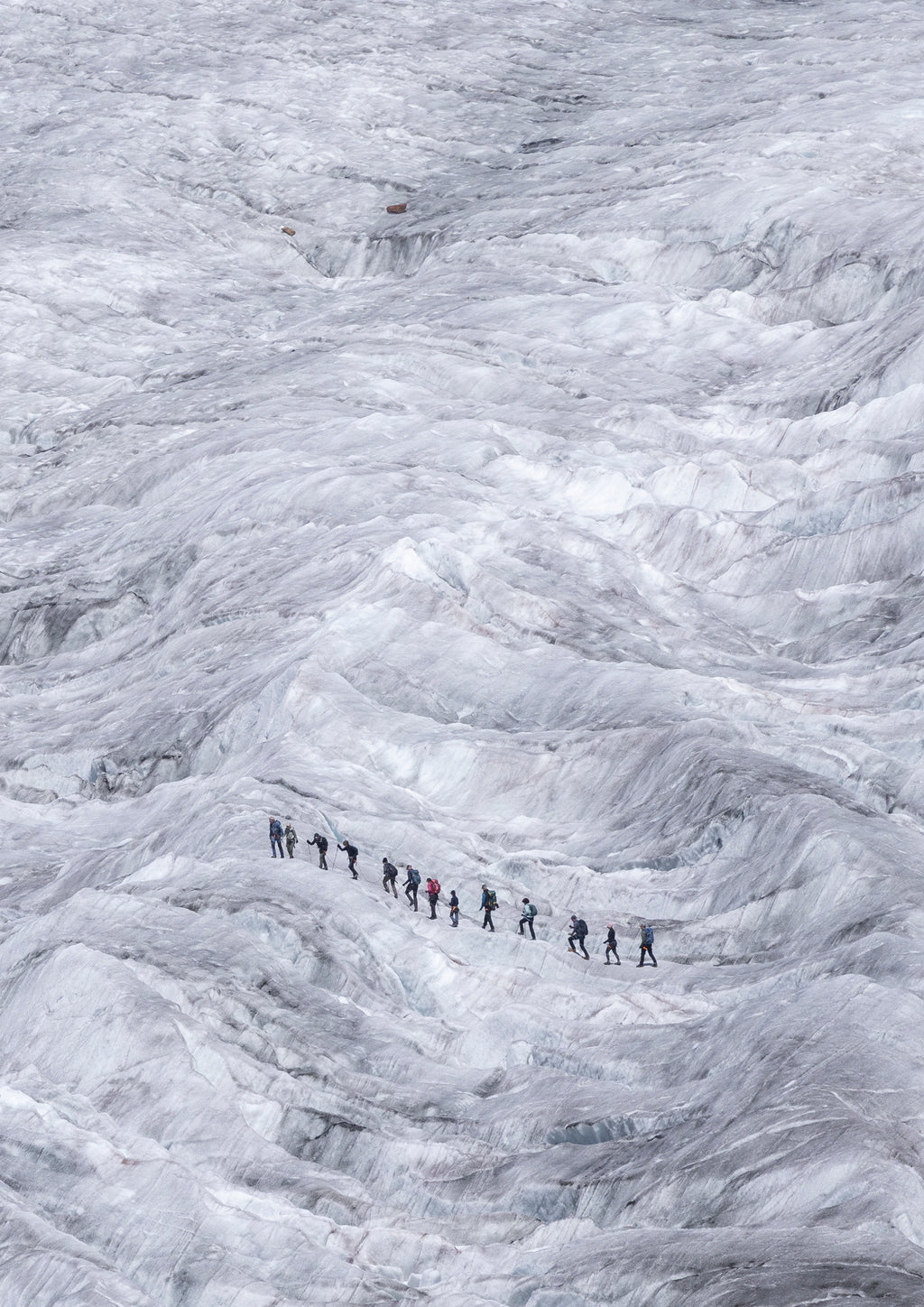 A group of mountaineers trails across the Aletsch Glacier in Switzerland