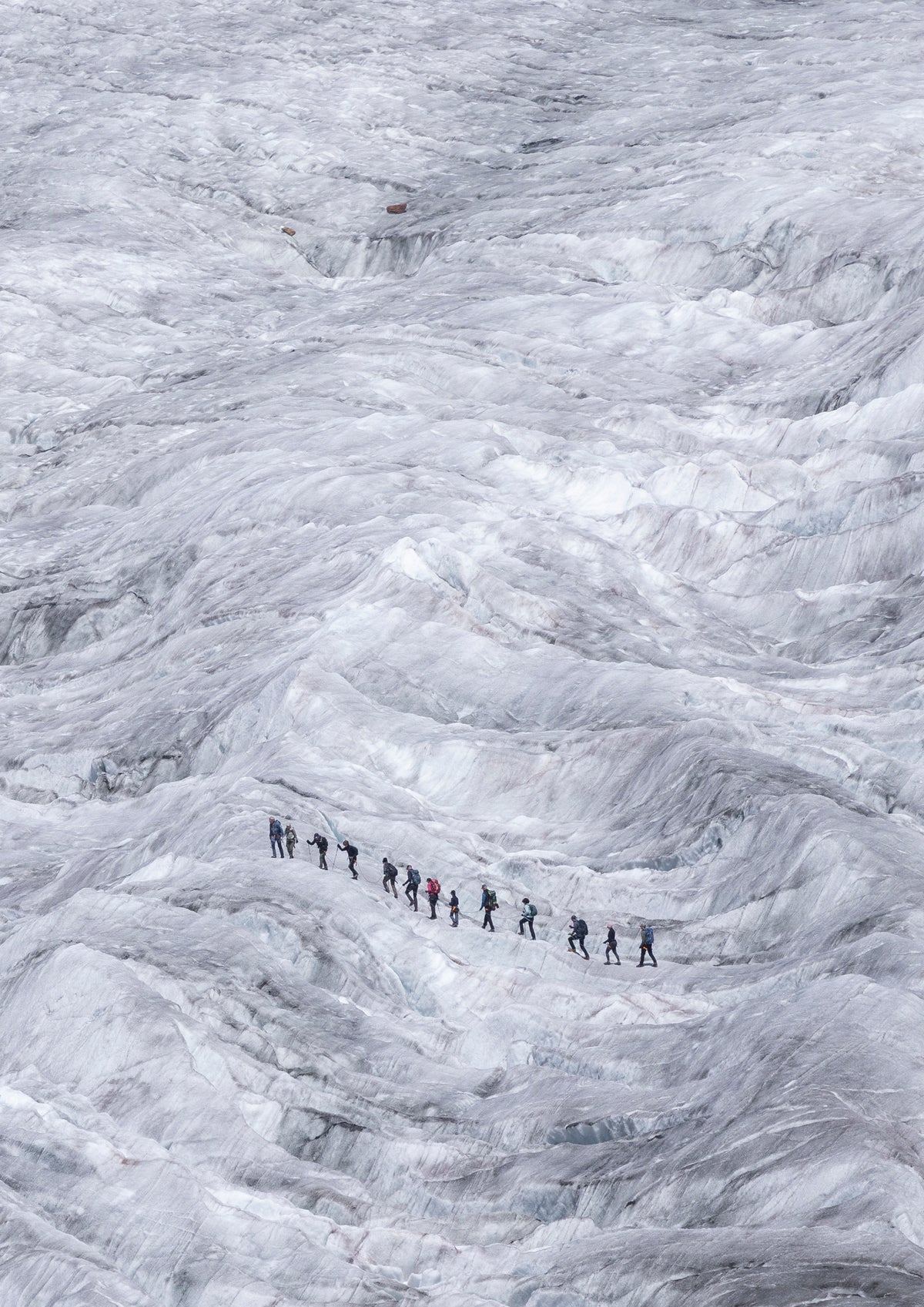 A group of mountaineers trails across the Aletsch Glacier in Switzerland