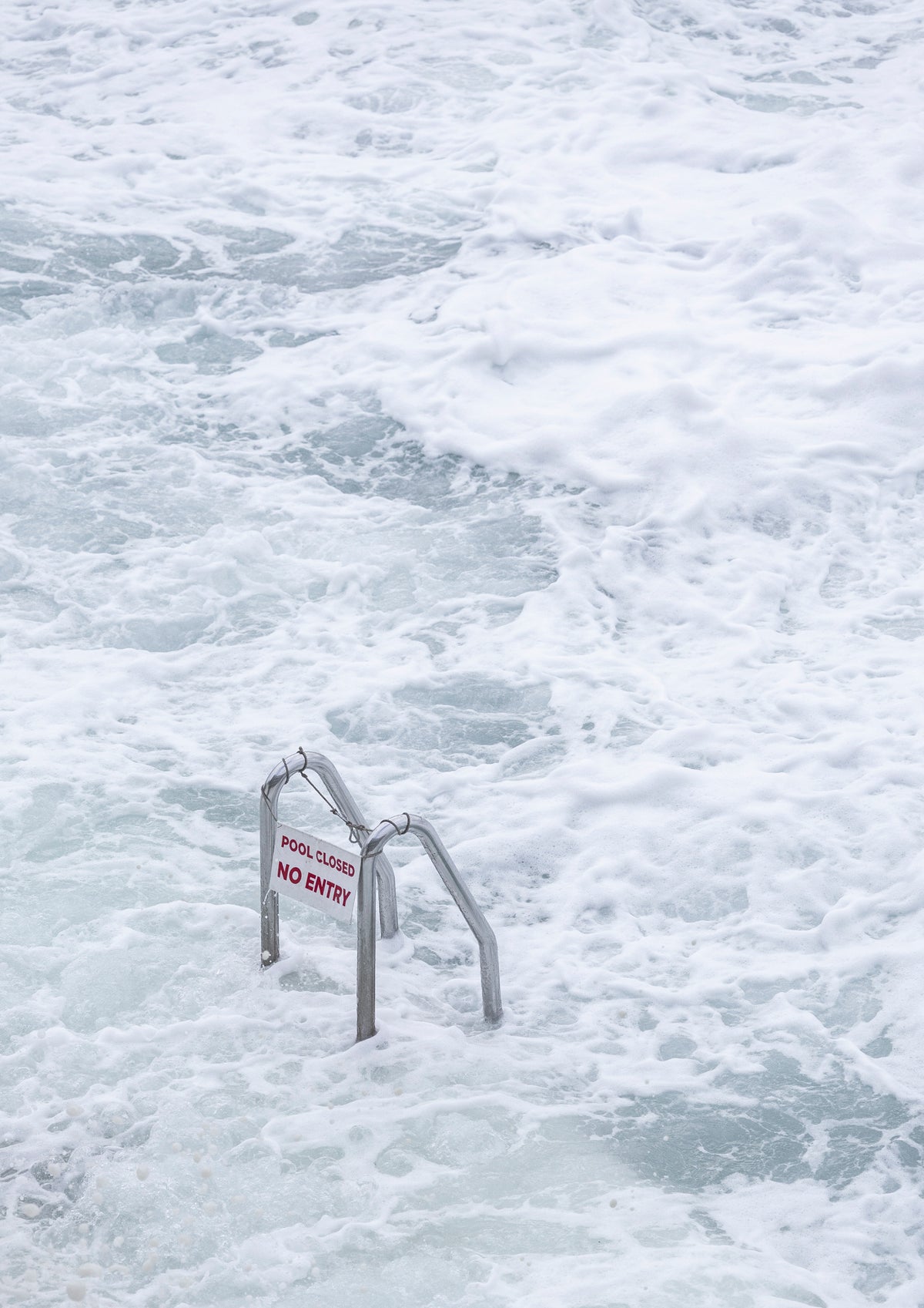 Bondi Icebergs ladders denoting pool closure during a storm swell