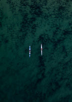 Two surfskis returning to shore side-by-side in Bondi Beach, Sydney, Australia