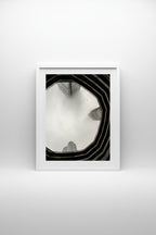 View through the Vessel in New York up to tall buildings shrouded in fog.